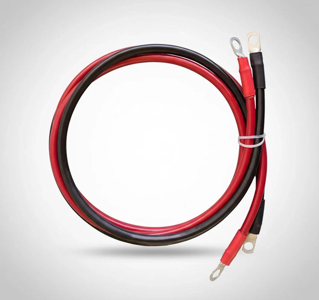 Red and black solar generator battery cables with ring terminals on white background