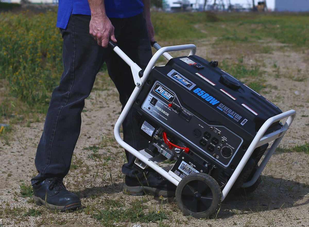 Portable Pulsar PG6580E generator in black, with dual handles, being wheeled across a dirt surface.