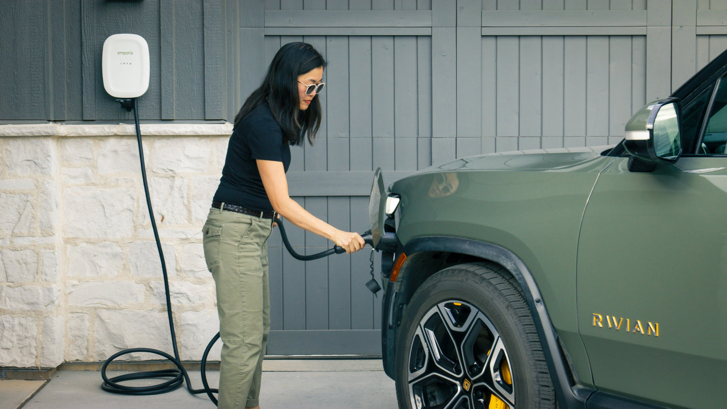 Lady driver hooked up EV charger to her vehicle. 