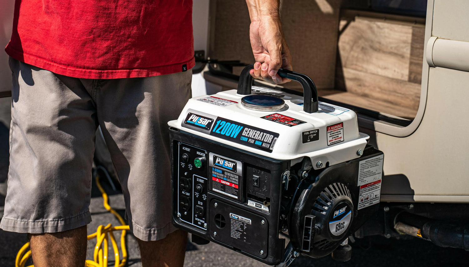Person holding portable 1200W generator outdoors near RV, SolarFlares Generators energy solution