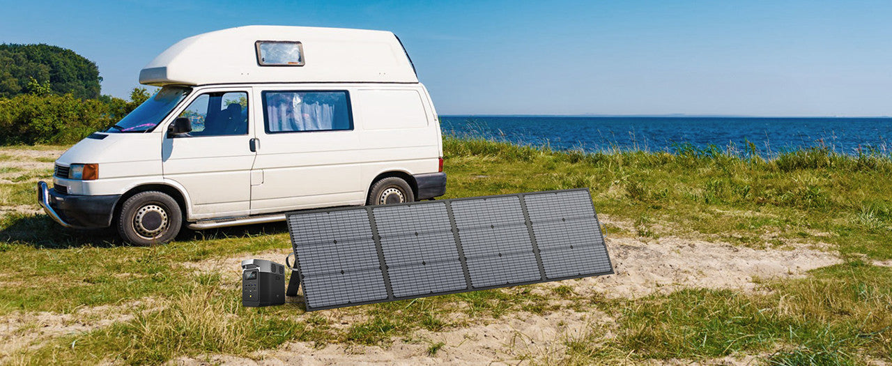 MHPOWOS 220W foldable solar panel displayed on sandy ground near a white camper van, showcasing its multiple solar cells.