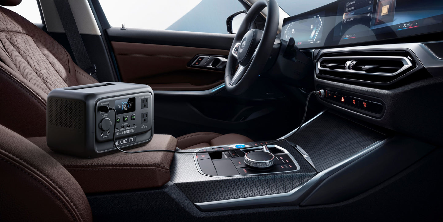 Portable BLUETTI Elite 30 V2 power station sits on a brown leather car seat, displaying its control panel and connections.