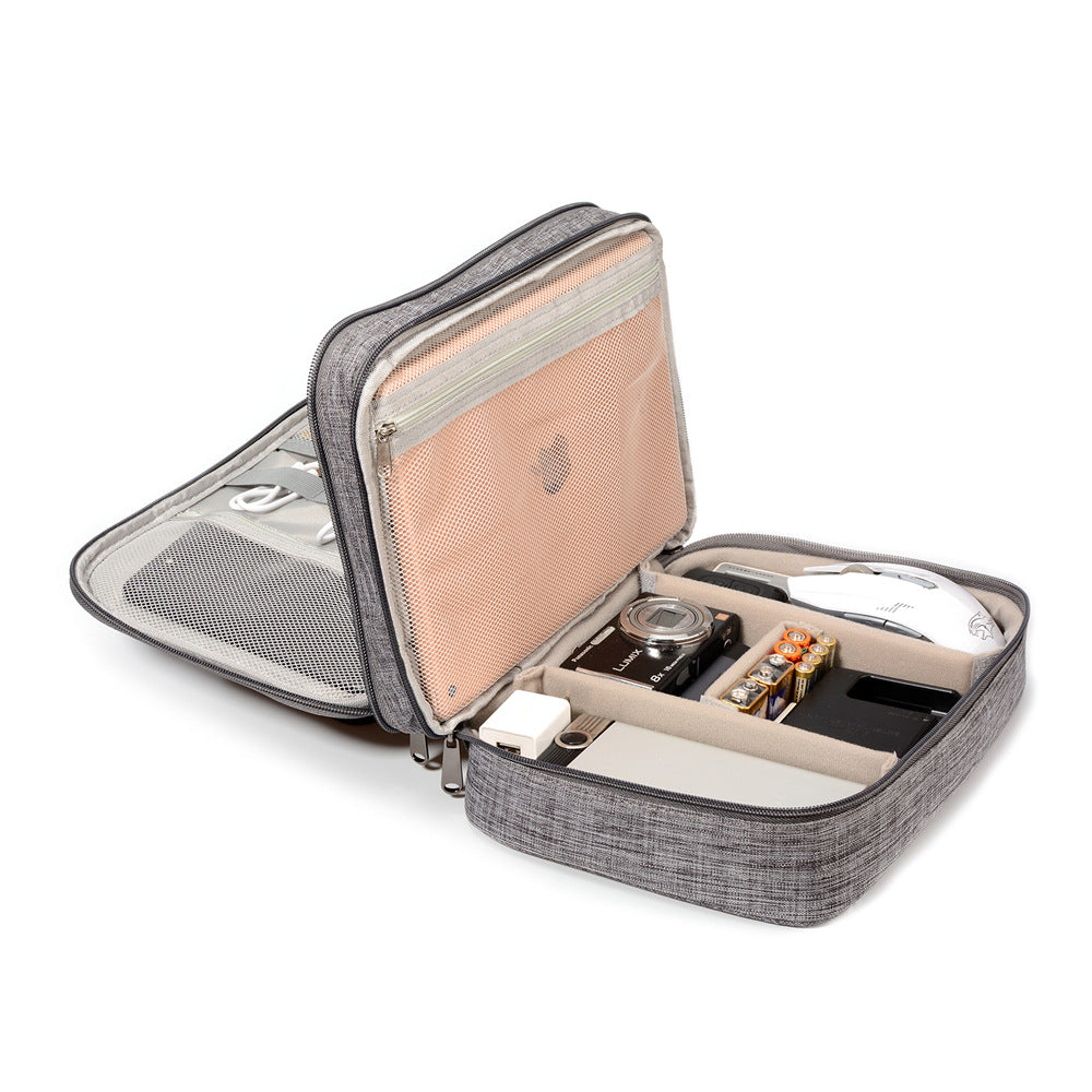 Portable gray organizer case with camera, mouse, batteries, cables, and gadgets neatly stored
