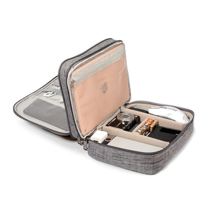 Portable gray organizer case with camera, mouse, batteries, cables, and gadgets neatly stored