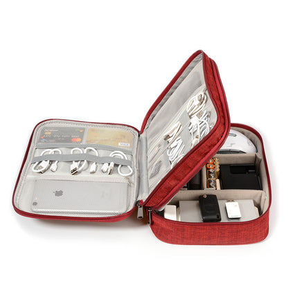 Red electronic organizer case with cables, chargers, batteries, and tech accessories neatly stored.