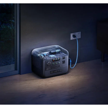 BLUETTI AC50B Portable Power Station with a sleek black design, plugged in with a blue charging cable, displaying power metrics.