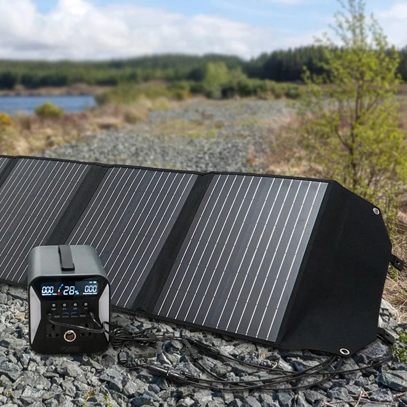 Solar panel connector adapter cable positioned next to a portable power station on rocky terrain with greenery in the background.