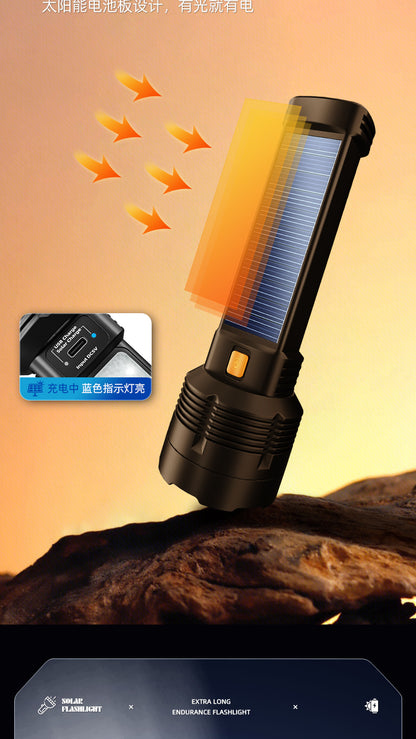 Black solar flashlight with side solar panel, USB charging port, and an orange power button, designed for outdoor use.
