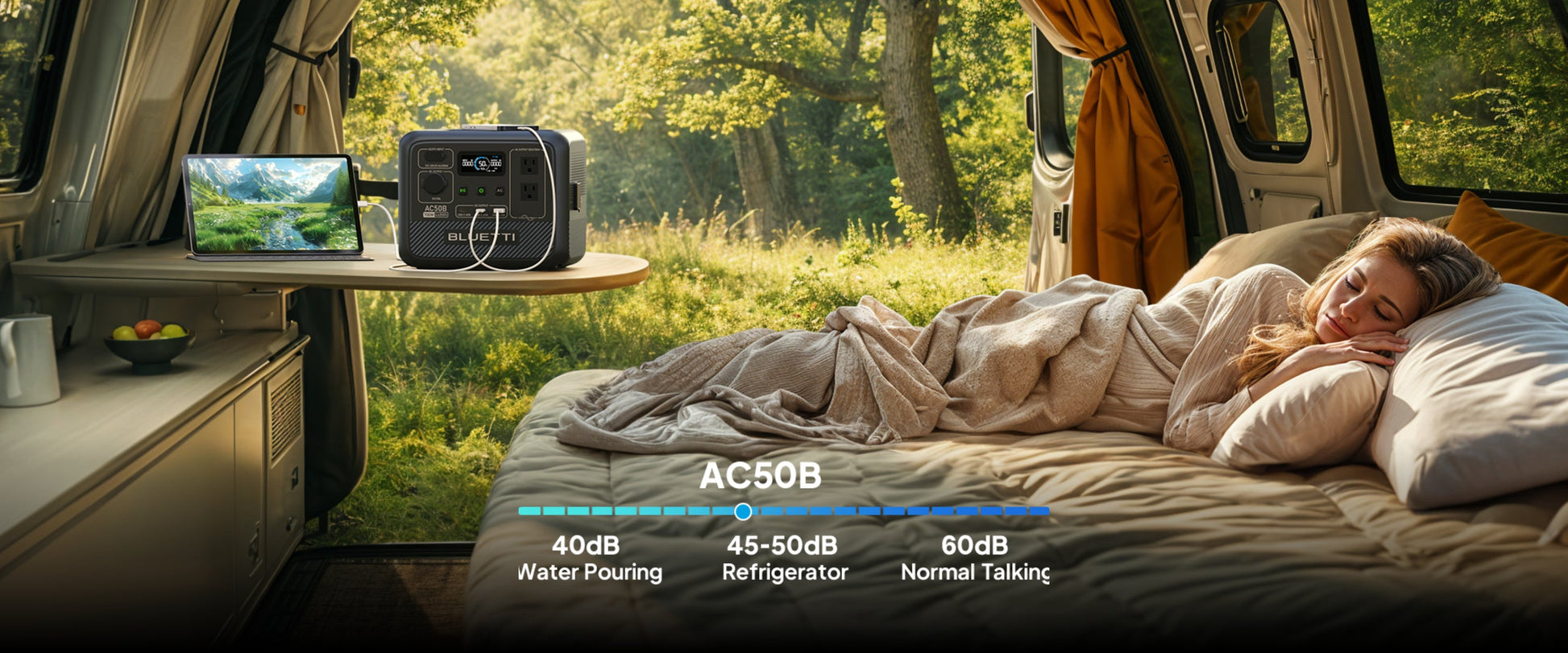 Portable BLUETTI AC50B power station on a table, charging a laptop while a woman sleeps peacefully nearby in a cozy setting.