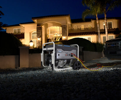 Portable generator powering a large home at night, outdoor emergency backup energy solution