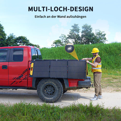 Worker sets up portable solar panels on red pickup truck outdoors, SolarFlare Generators renewable energy