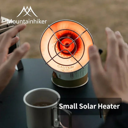 Small solar heater with a mug of coffee on a table, branded 'Mountainhiker'.