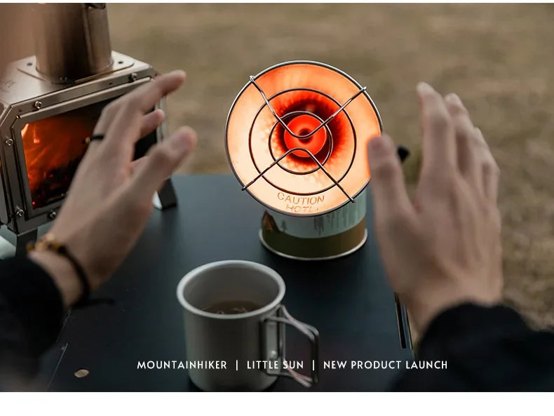 Person holding a cup of coffee near a small lamp with 'Mountainhiker' branding.