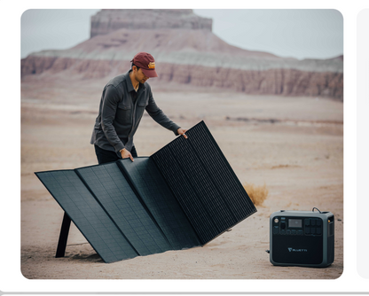 Person setting up solar panels in an open area. 