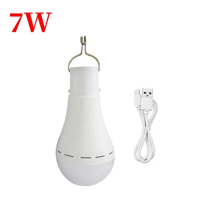Rechargeable solar camping light in white with a hook for hanging, includes USB charging cable. Features a durable design.
