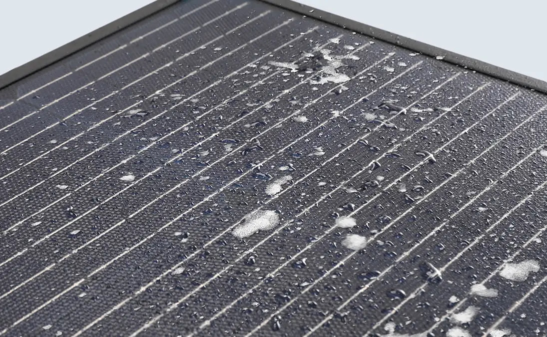 Renogy 400W portable solar suitcase with water droplets on the surface, showcasing its durable and waterproof design.