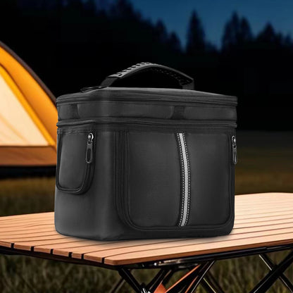Black carrying case for BLUETTI EB3A, featuring a handle and waterproof fabric, set on a wooden table near a tent.