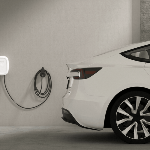 Home EV charger for Tesla mounted on garage wall, promoting renewable energy solutions
