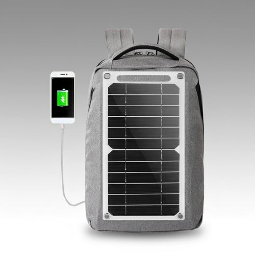 Gray backpack with built-in solar panel charging a smartphone, portable solar generator kit