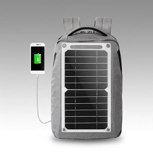 Gray backpack with built-in solar panel charging a smartphone, portable solar generator kit